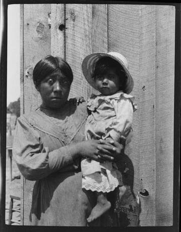 An unidentified Native American woman holding a child