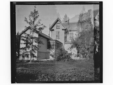 Unidentified two-story house with young tree