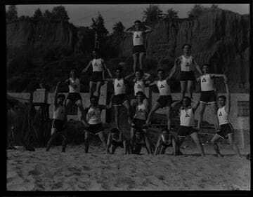 Acrobats pose in human pyramid, Gables Beach Club, Santa Monica