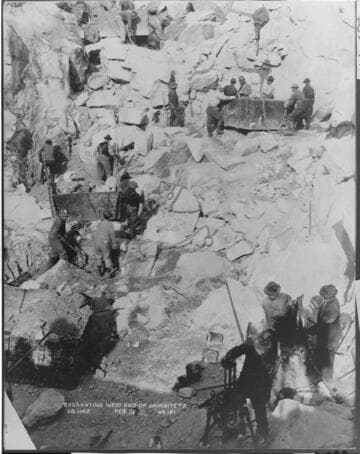 This February 1913 photo shows workmen preparing the bedrock for the foundations of the west end of Dam #3