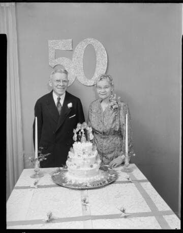 Husband & wife with their 50th wedding anniversary cake
