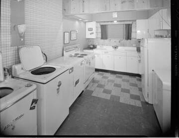 Residential kitchen with electric range, and laundry