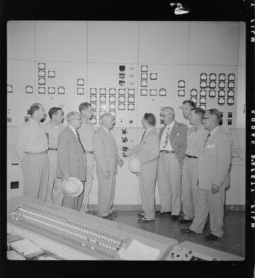 Men touring a new control room