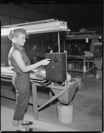 Lady factory worker at conveyor belt