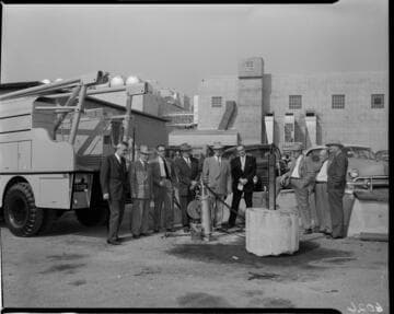 Men in group shot around work site