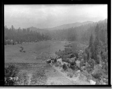 Open field with shed at edge