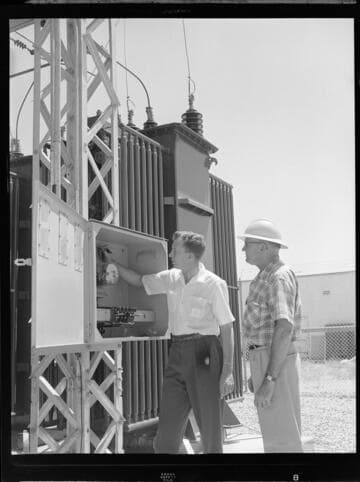 Men inspecting meter box at North East City Substation