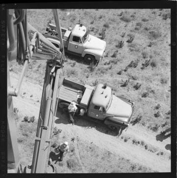 View from raised bucket of desert and truck below