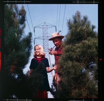 Kids picking out a live tree at a Christmas Tree Farm