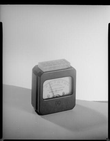 Light meter close-up & lady using the meter at desk