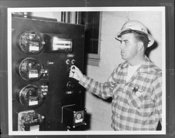 Substation operator, Bob Vail, setting switch at Moorpark Substation