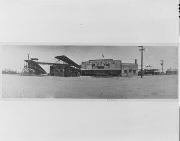 The Company's facilities at El Centro in 1918 included railroad car icing platforms (left), and ice plant (center), and a gas-engine powered generating plant and substation (extreme right)