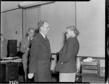 Lady with corsage talking to man