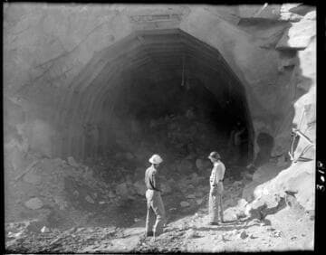 Construction work at mouth of Big Creek 4's powertunnel.  Hayes and friend are by dusty tunnel mouth with rubble