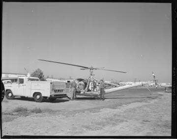 Two men standing by Edison Hiller 12E Helicopter (N5349V)
