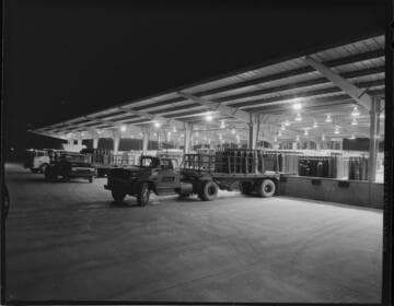 Loading dock with trucks picking up pressurized tanks