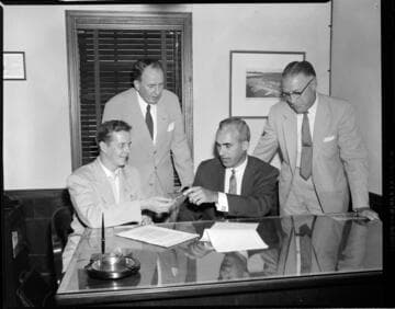 Men signing documents