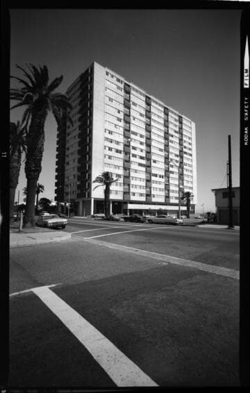 High-rise hotel with "Embers Shoreline Restaurant" below