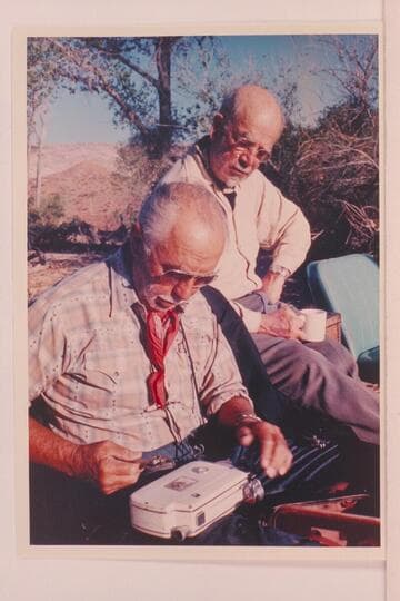 Archeyes Masland takes his camera apart with pliers as Dock Marston wonders; Halls Creek