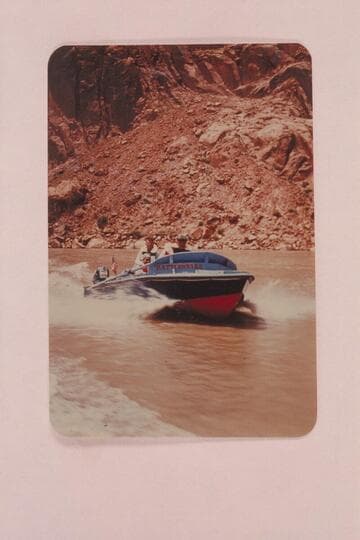 Shakedown cruise into Glen Canyon.  Rod Sanderson at the wheel, Harvey Butchart sits astern and Lodell Mathews sits in the cockpit