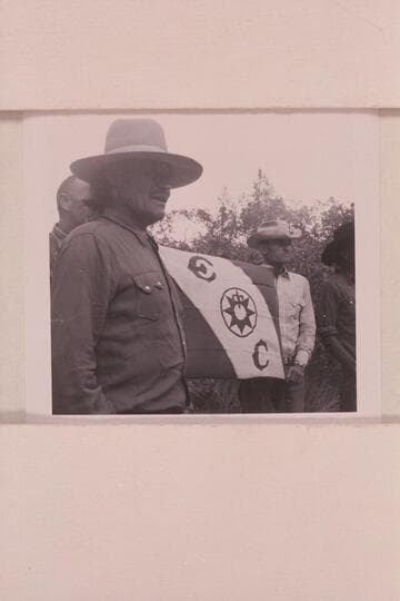 Official stamp of exploration of middle fork of 73.  Buck Whitehat and Tom Daly hold the flag