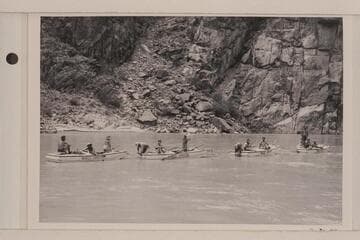 The four Nevills skiff and their passengers at the end of the Nevills' final run of Grand Canyon.  L to R:  Anspach, Reilly, Kendall, Wright, Anspach, Abbott, Jim Rigg, Joan Nevills, Nevills (standing), Ruth Rigg and Masland