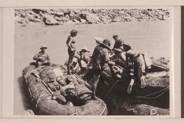 The "Queen Mary" of the Georgie White fleet.  Three pontoons tied together and a 10-man neoprene tied on top of the middle unit.  Georgie White is standing near the stern