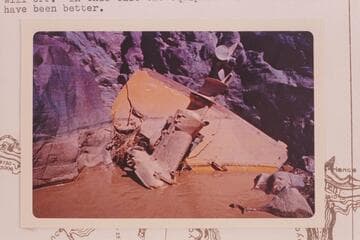 The transom of one of the Harris-Brennan outboard boats together with the motor which separated from the hull in Hance Rapid in 1962, June.  In small rock cove about Mile 77 and just above the location of the hull