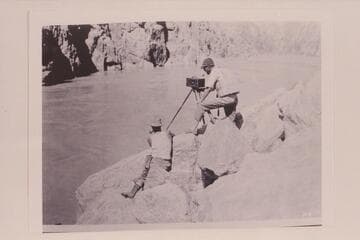 Moore and LaRue taking a panoram picture hear foot [sic] of Sockdolager Rapid.  Note the dangerous breeches and boots worn by Moore