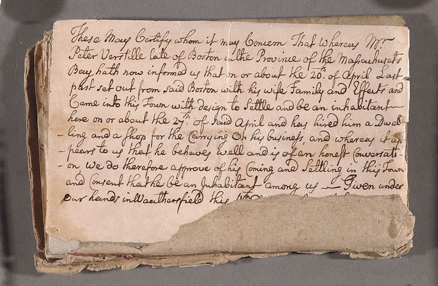 The cover of a diary, partially torn, with cursive writing.